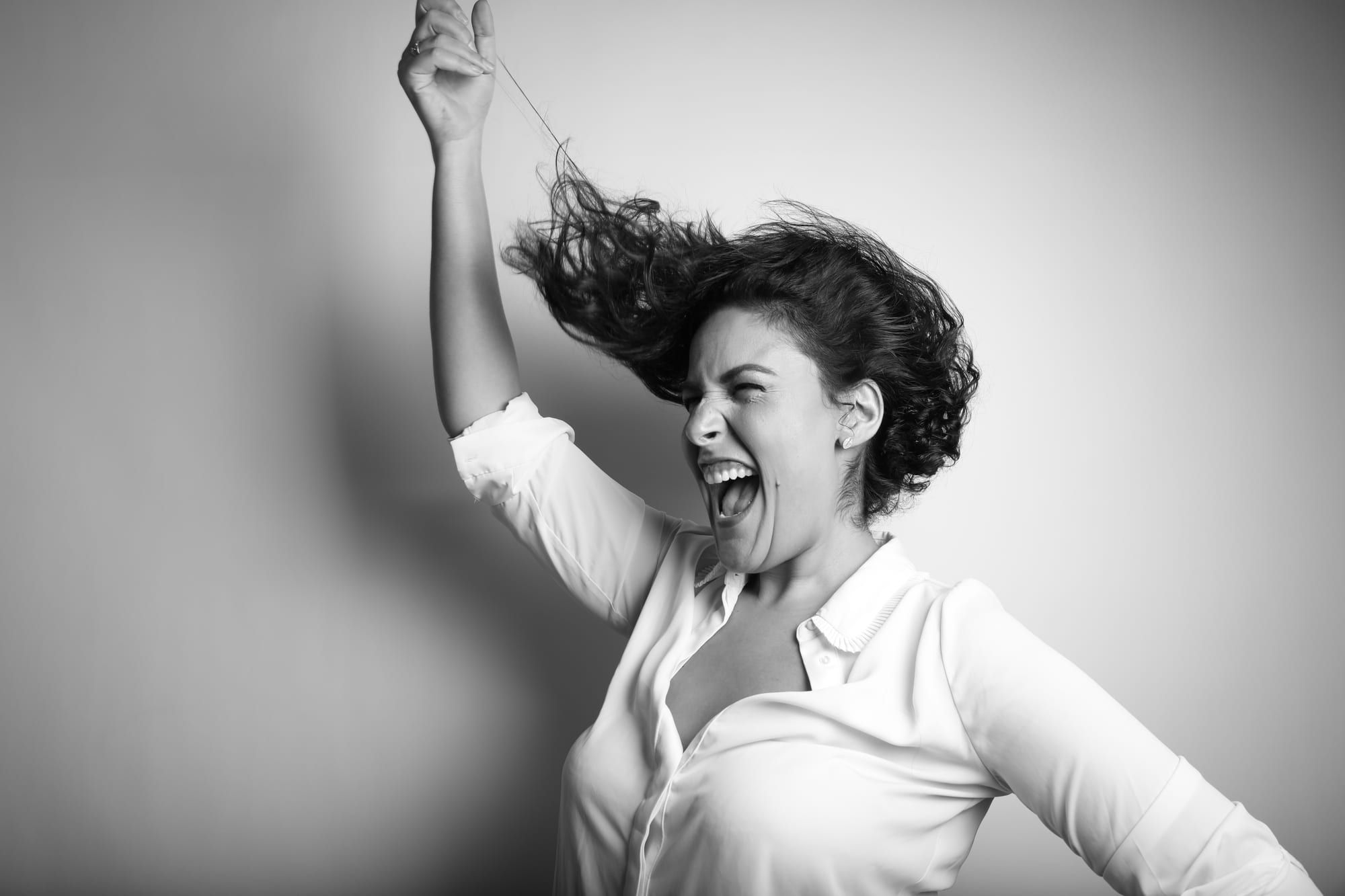 Noam Shuster-Eliassi mid-shout, one arm raised, hair flying